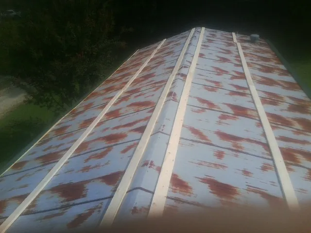 Rusted metal roof panels with new wood purlins before replacement — Storm Damage Roof Repair in Gambrills by Roofing Brothers